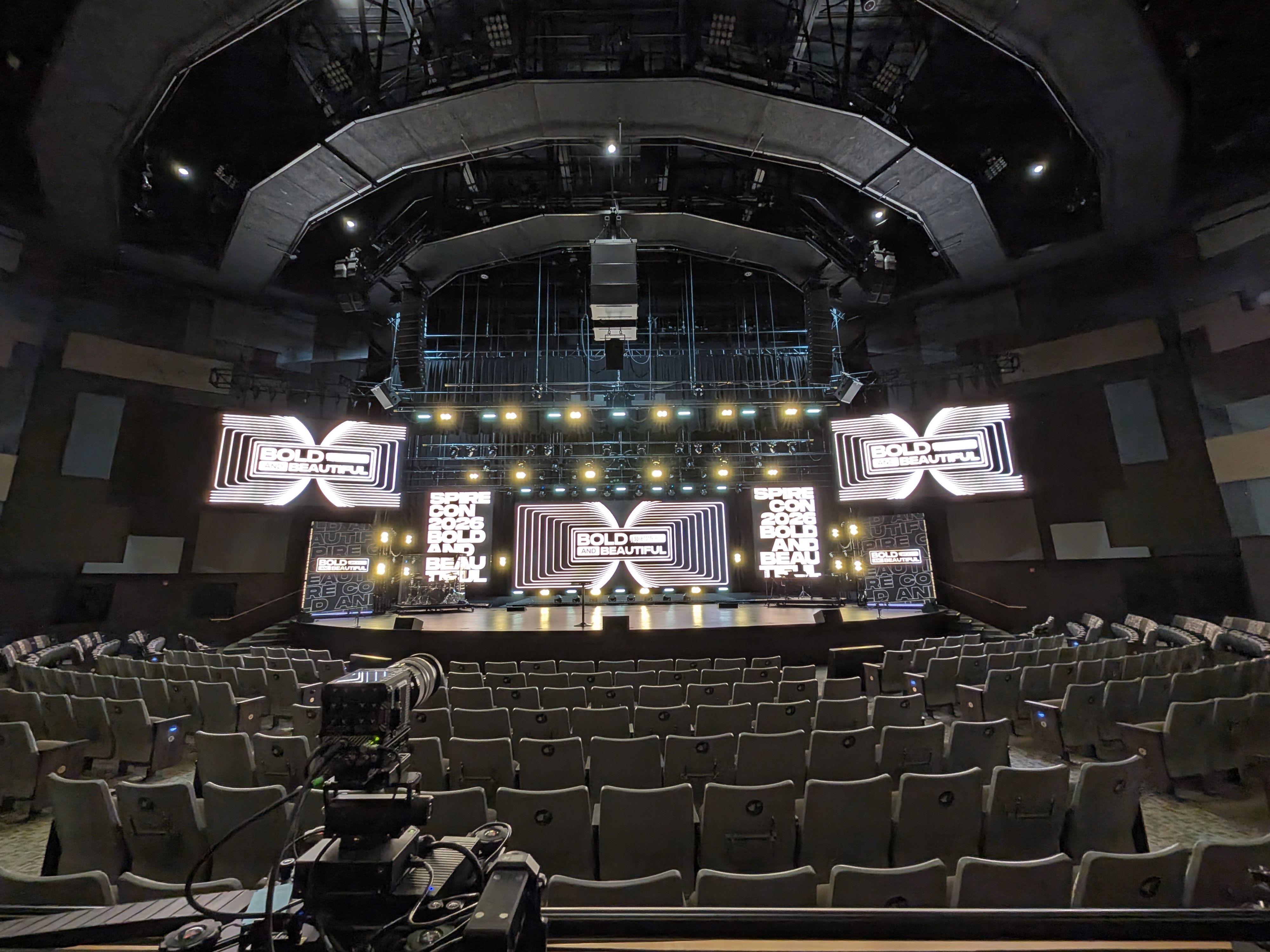Auditorium stage and production positions viewed from the back of the room